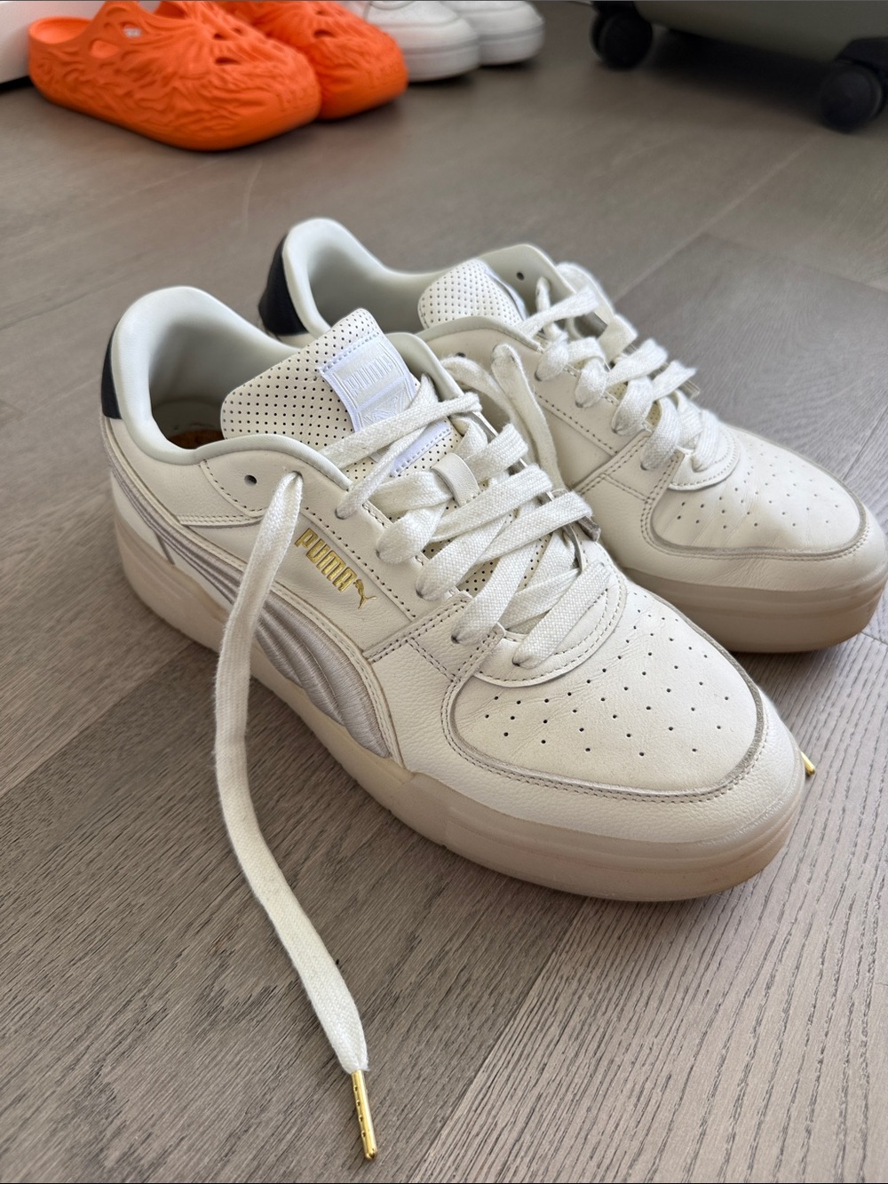 Puma Men’s White Sneakers with Gold Accents and Black Heel